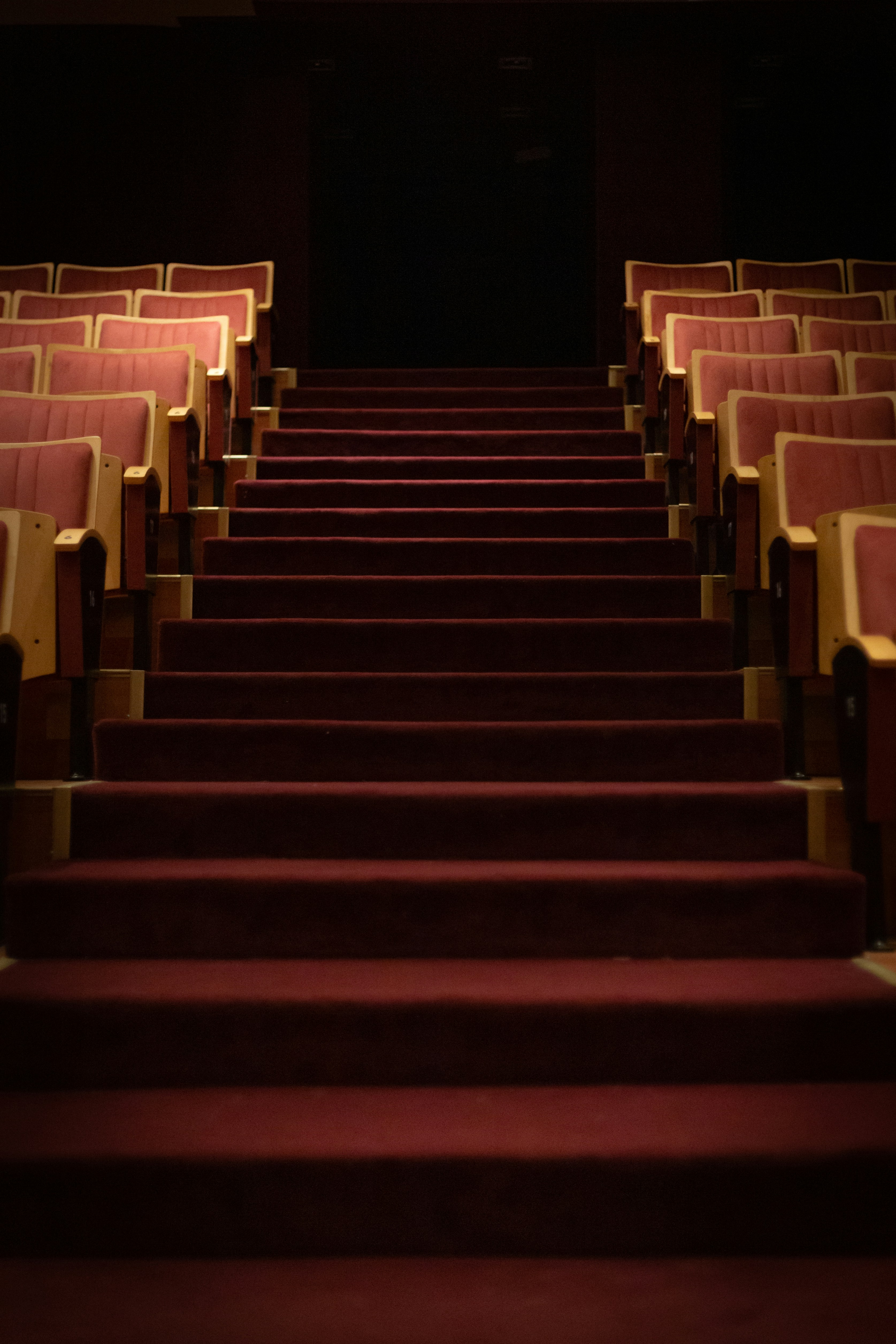Empty theatre, velvet steps leading up to the stage